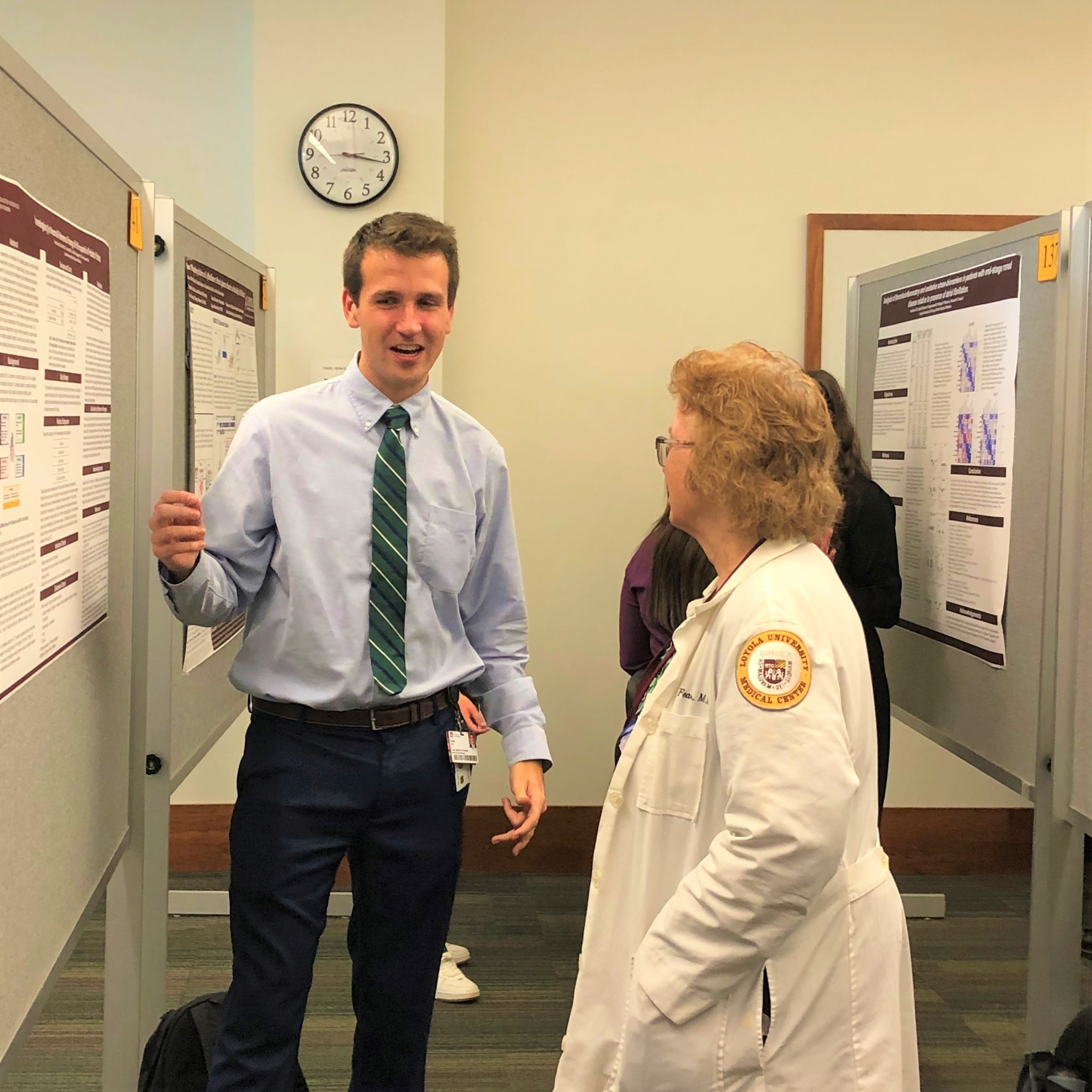 Student presents to a professor at the 2024 St. Alberts Day Poster Session